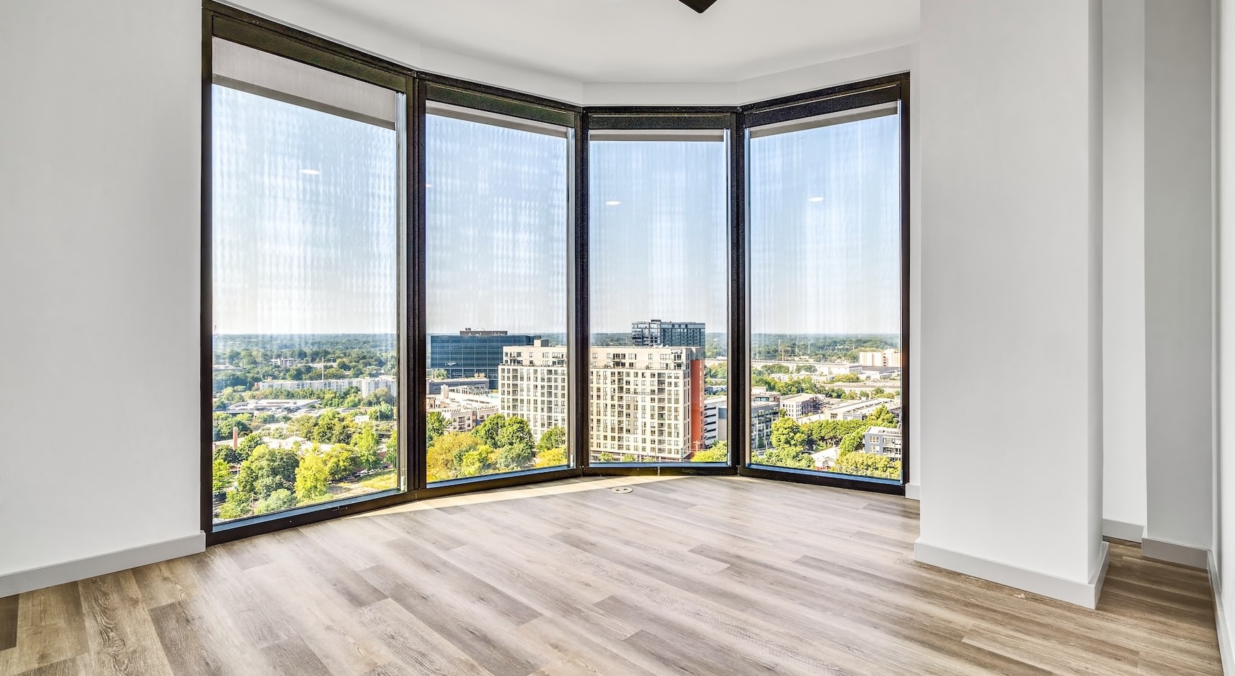 unfurnished room with large windows